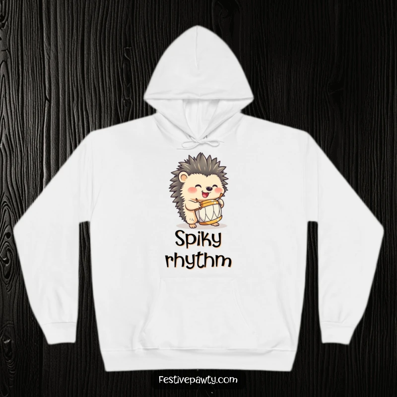 Funny hedgehog hoodie, happily playing a miniature drum with sharp quills, exuding funny musical passion and cozy vibes.
